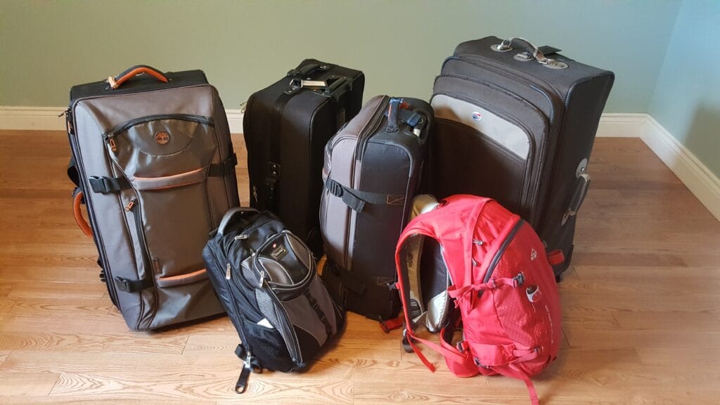 pile of luggage and backpacks