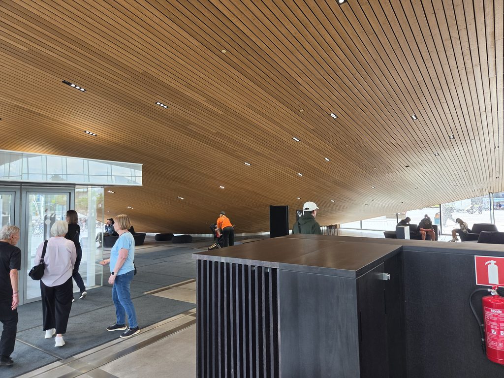 inside oodi library low wooden ceiling and people visiting