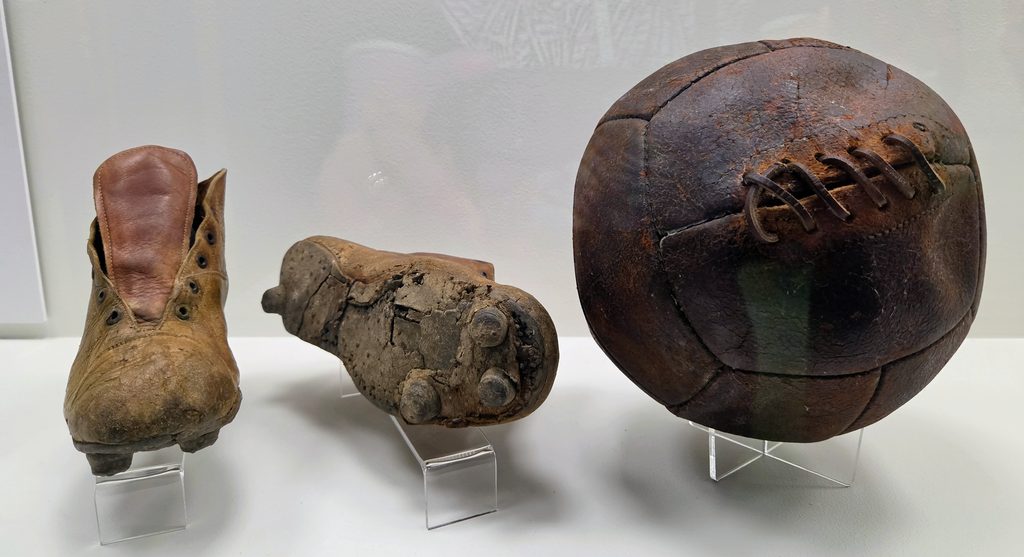 Football cleats and 1930s leather stitched ball