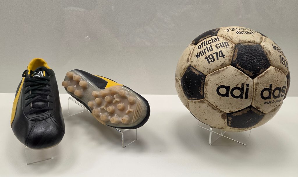 Black and yellow cleats and soccer ball from 1974