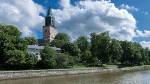 Turku, Finland, with historic buildings and a tower beside the Aura River