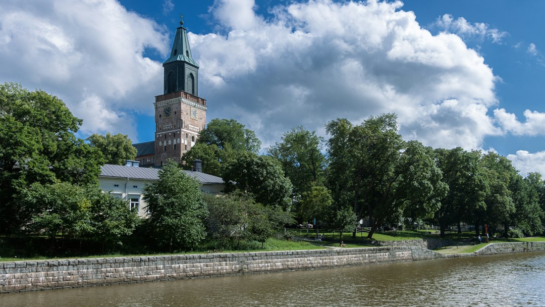 Turku, Finland, with historic buildings and a tower beside the Aura River